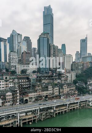 Chongqing, China - Dec 22, 2019: CBD Skyscrapers near Hongya dong cave by Jialing river Stock Photo