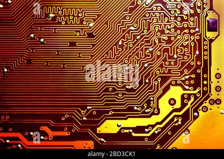 Gold electronic mother board circuit close up macro background. Stock Photo