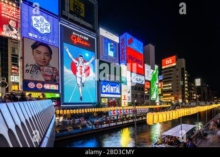 Osaka, Japan, August 2019 – Glico Running Man neon sign at Dotonbori canal is the most popular Osaka's landmark Stock Photo