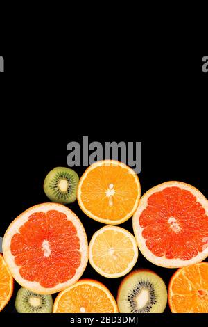 Citrus fruits background orange lemon grapefruit mandarin kiwi. Flatlay composition Stock Photo