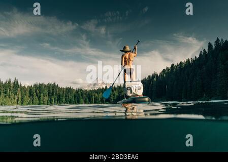 A young woman enjoys a standup paddle board on Lost Lake in Oregon. Stock Photo