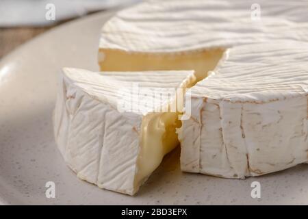 Close up on a Camembert cheese on white plate Stock Photo