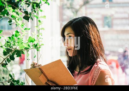 beautiful agronomical engineer taking notes in the greenhouse Stock Photo