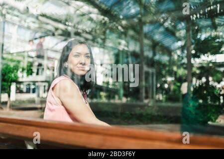 beautiful agronomical engineer sitting in the greenhouse Stock Photo