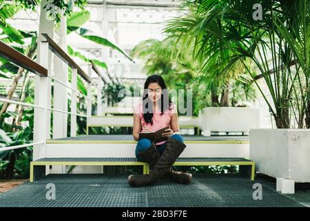 beautiful agronomical engineer taking notes in the greenhouse Stock Photo