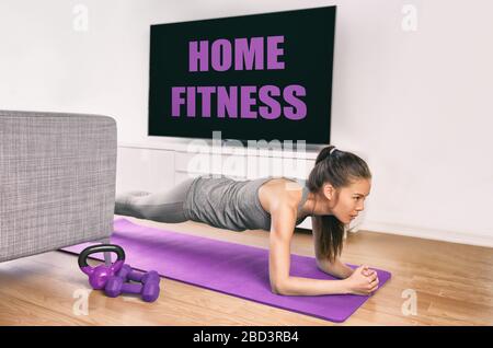 https://l450v.alamy.com/450v/2bd3rb4/fitness-workout-staying-at-home-indoors-asian-girl-doing-plank-exercises-to-exercise-core-watching-tv-videos-of-fit-class-young-woman-training-muscles-in-front-of-the-tv-without-going-to-the-gym-2bd3rb4.jpg