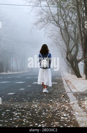 Amazing scene in early morning with girl wear backpack standing