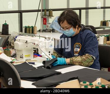 New York, United States. 06th Apr, 2020. Worker wearing social distances t-shirt works on production line run by Crye Precision to produce protective equipment for health professionals at Brooklyn Navy Yard (Photo by Lev Radin/Pacific Press) Credit: Pacific Press Agency/Alamy Live News Stock Photo