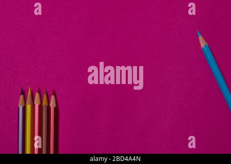 Multi colored crayons at magenta background with copy space. Stock Photo