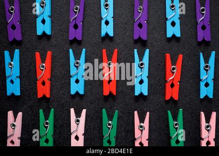 Small clothespins on a black table. Stock Photo