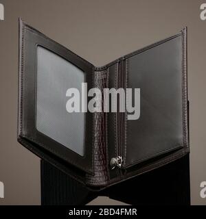 Fashionable designer leather wallet on a brown background Stock Photo