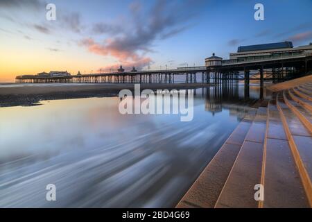 The North Pier at Blackpool captured from the sea wall at sunset Stock Photo