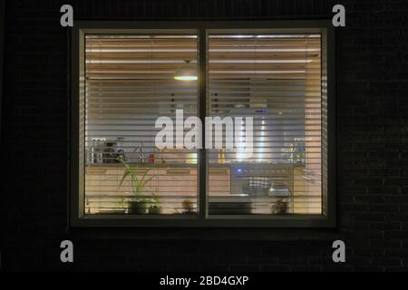 Cozy wooden kitchen, view from outside in the evening. modern retro interior Stock Photo