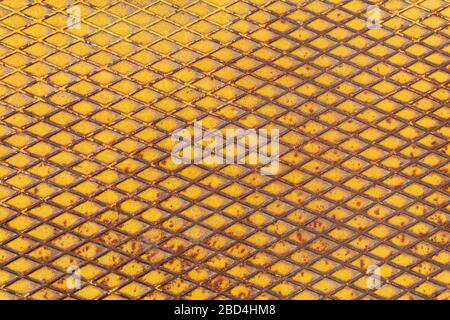 Yellow Painted Metal With Repeating Pattern Stock Photo