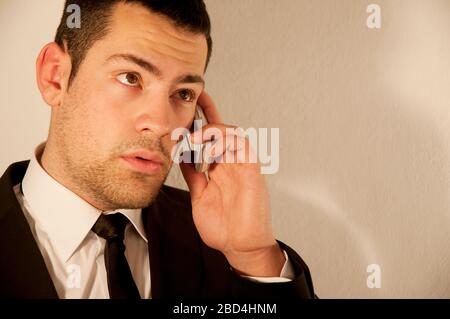 Young executive using mobile phone. Stock Photo