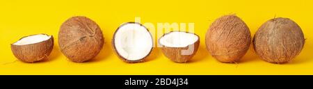 Coconuts on yellow background. Tropical fruit. Summer Stock Photo