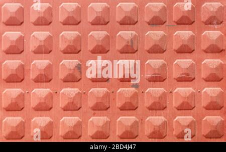 Red Painted Metal Texture With Repeating Elements Stock Photo