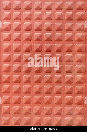 Red Painted Metal Texture With Repeating Elements Stock Photo