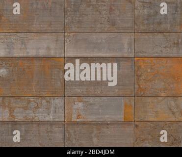 Rusty metal plates cover a modern facade of a building in an exciting way. Stock Photo