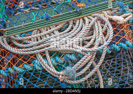 Closeup detail of lobster pots and rope on a harbor quayside Stock Photo