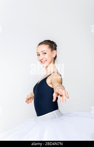 Young ballerina practising ballet moves in the studio Stock Photo