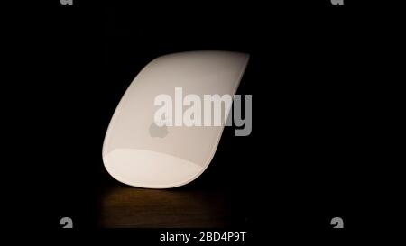 White computer mouse, set on a wooden table. Stock Photo