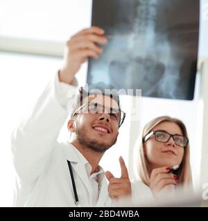 two orthopedic doctors looking at the x-ray of the patient Stock Photo