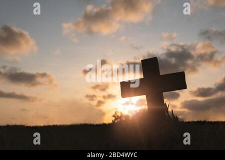 Silhouette Jesus christ death on cross crucifixion on calvary hill in sunset good friday risen in easter day concept for Christian praise for holy spi Stock Photo