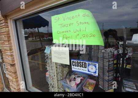 Abilene, TX is the county seat of Taylor County. Even in this mid-sized Texas city, signs of a pandemic are evident, including this one at local small business. Stock Photo