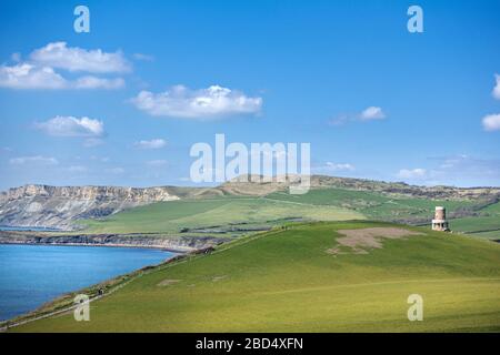 View down the Jurassic coastline in Dorset towards Kimmeridge Bay, showing Clavell Tower and Hobarrow Bay in the distance Stock Photo