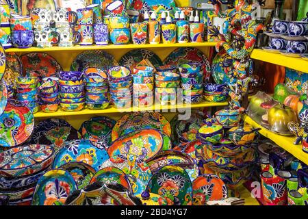 Colorful traditional Mexican pottery. Talavera style. Souvenirs on sale in local market of Guanajuato, Mexico. Stock Photo