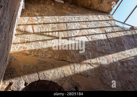 Sun rays entering the sanctuary shines on the walls of the inner sanctums in Luxor Temple Stock Photo