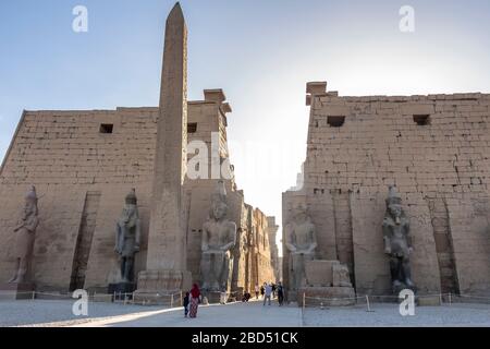 Luxor, Egypt - 27th Dec 2019: The colossal statues of Ramesses the Great and obelisk at the first pylon of Luxor Temple Stock Photo