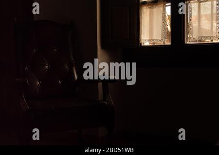 Armchair and window in low key Stock Photo