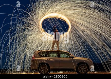 A steel wool on fire at night (night photography using a slow shutter speed) - selective focused. Stock Photo