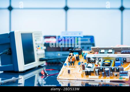 Debugging electronics device. PCB witch microcontroller in electronics laboratory Stock Photo