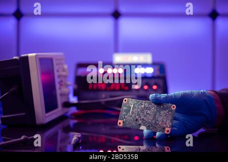 Debugging electronics device. PCB witch microcontroller in electronics laboratory Stock Photo