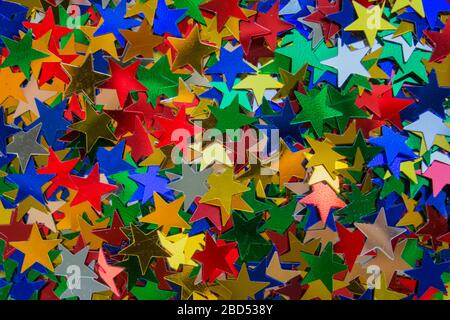 Colorful star shaped sparkles as the best background for your creative design with copy space. Festive concept Stock Photo
