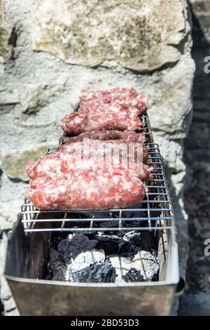 typical Abruzzo sausage grilled on fire in the woods in italy Stock Photo