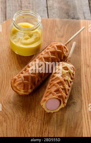 Corn dogs and a jar of mustard Stock Photo