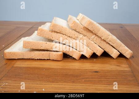 Half a dozen slices of white bread photographed in a kitchen setting Stock Photo