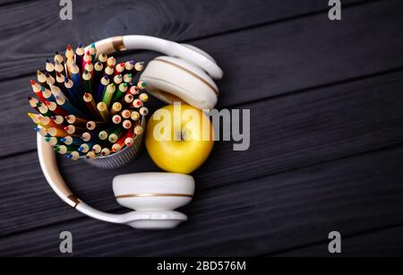 Modern workplace with headphones and colored pencils. Creative profession, working place. Top view. Generating ideas and brainstorm concept Stock Photo