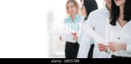 Manager and employees discussing business documents. Background for text with people in blur Stock Photo