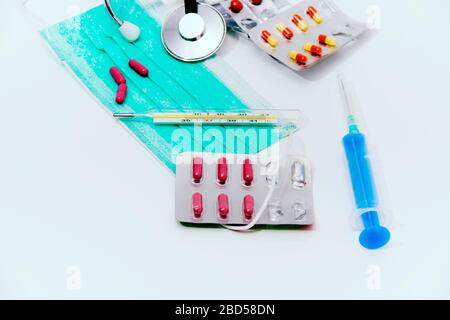 photo-of-the-set-for-flu-treatment-pills-thermometer-nasal-sprays-protective-surgical-mask-stethoscope-syringe-2bd58dn.jpg