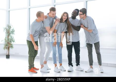 team of young professionals standing in a bright office Stock Photo