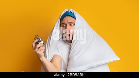 Emotional man in terror looks at clock Stock Photo
