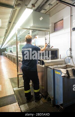 06 April 2020, Saxony-Anhalt, Arneburg: A fireman works in the fire brigade technical centre (FTZ) of the district of Stendal in the hose washing department. In the FTZ new hoses are stored and old hoses are checked and washed. In the afternoon the converted hose washing facility of the FTZ was put into operation. The hose washing is basically the washing machine for fire hoses. The FTZ cleans and tests about 10.000 of these fire hoses per year. In the district of Stendal up to 16,000 hoses are in use by the fire brigades. Each hose has to be washed after each deployment. Photo: Klaus-Dietmar Stock Photo