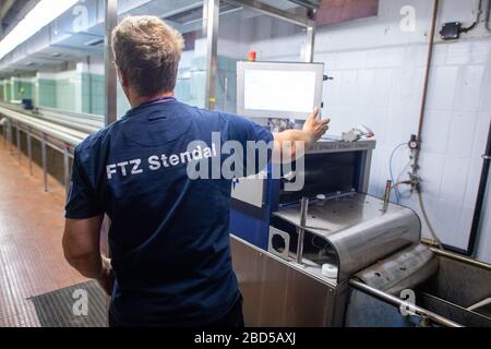 06 April 2020, Saxony-Anhalt, Arneburg: A fireman works in the fire brigade technical centre (FTZ) of the district of Stendal in the hose washing department. In the FTZ new hoses are stored and old hoses are checked and washed. In the afternoon the converted hose washing facility of the FTZ was put into operation. The hose washing is basically the washing machine for fire hoses. The FTZ cleans and tests about 10.000 of these fire hoses per year. In the district of Stendal up to 16,000 hoses are in use by the fire brigades. Each hose has to be washed after each deployment. Photo: Klaus-Dietmar Stock Photo