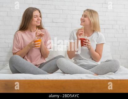Two girlfriends talking and drinking healthy detox cocktails Stock Photo
