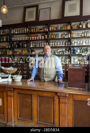 Chemist behind counter at the Black Country Living Museum in Dudley, West Midlands, England, UK Stock Photo